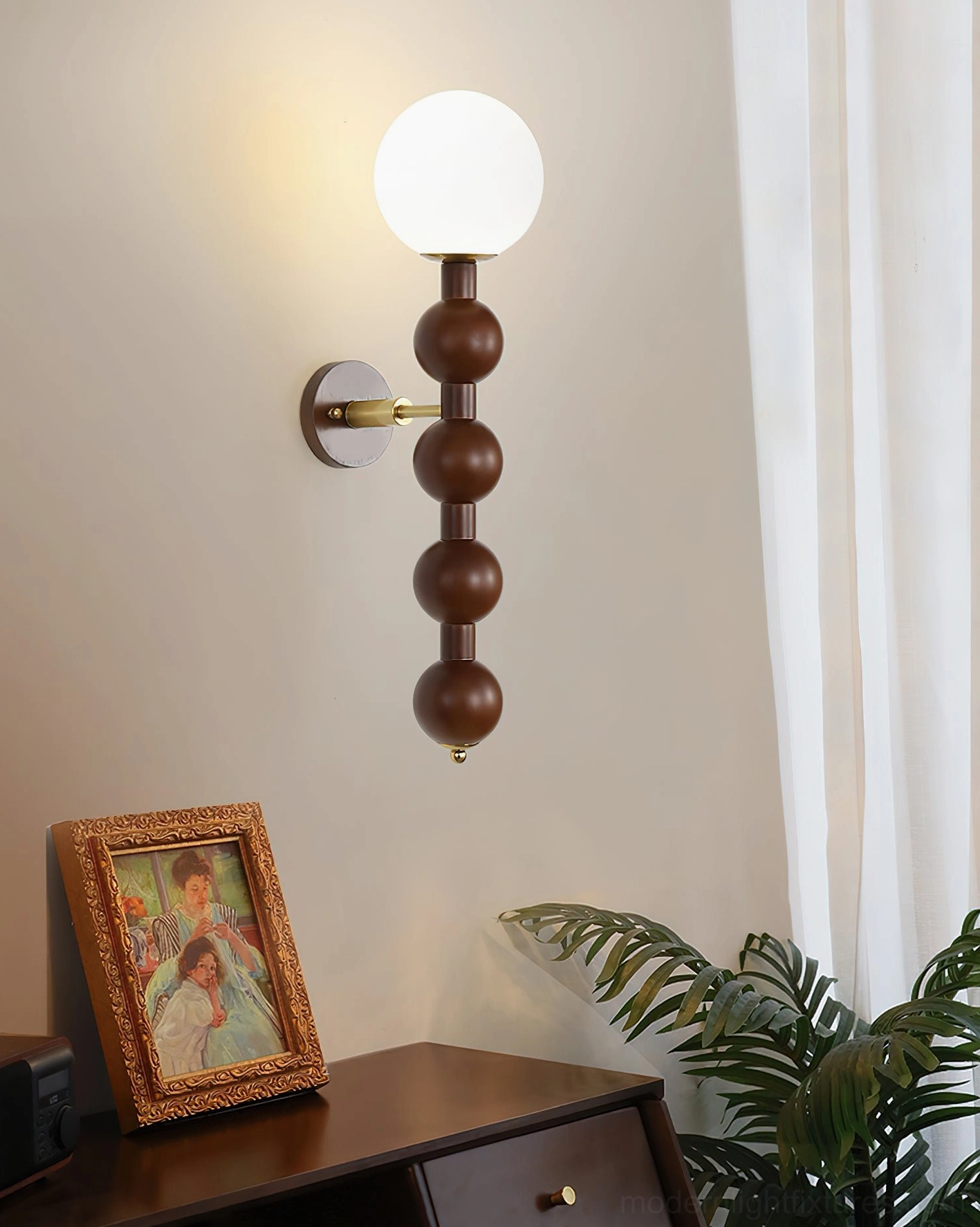 Beaded globe wall lamp in home library or study providing warm reading accent lighting