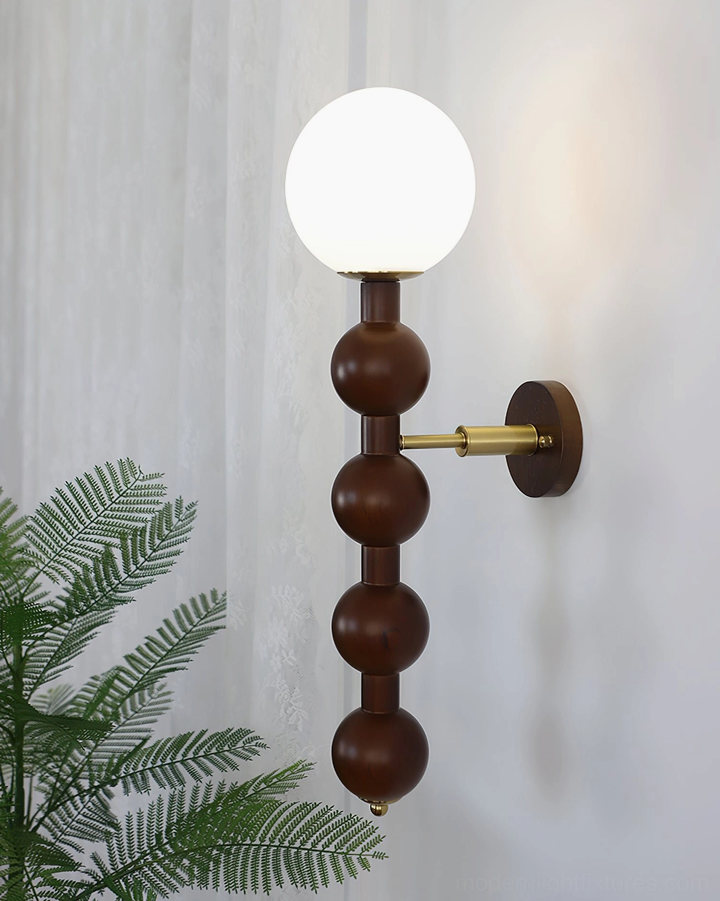 Globe beaded wall lamp in indoor space with green foliage and sheer curtains, solid wood construction