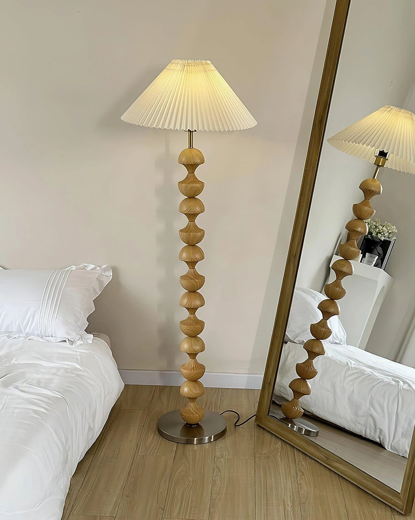 Close-up detail of hand-carved polished wooden beads on sculptural floor lamp column showing natural wood grain and warm texture