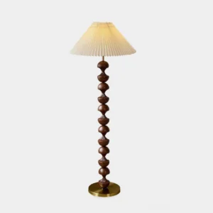 Beaded wood floor lamp with pleated cream shade and brass metal base, front view showcasing dark brown stacked wood pole and sculptural column design