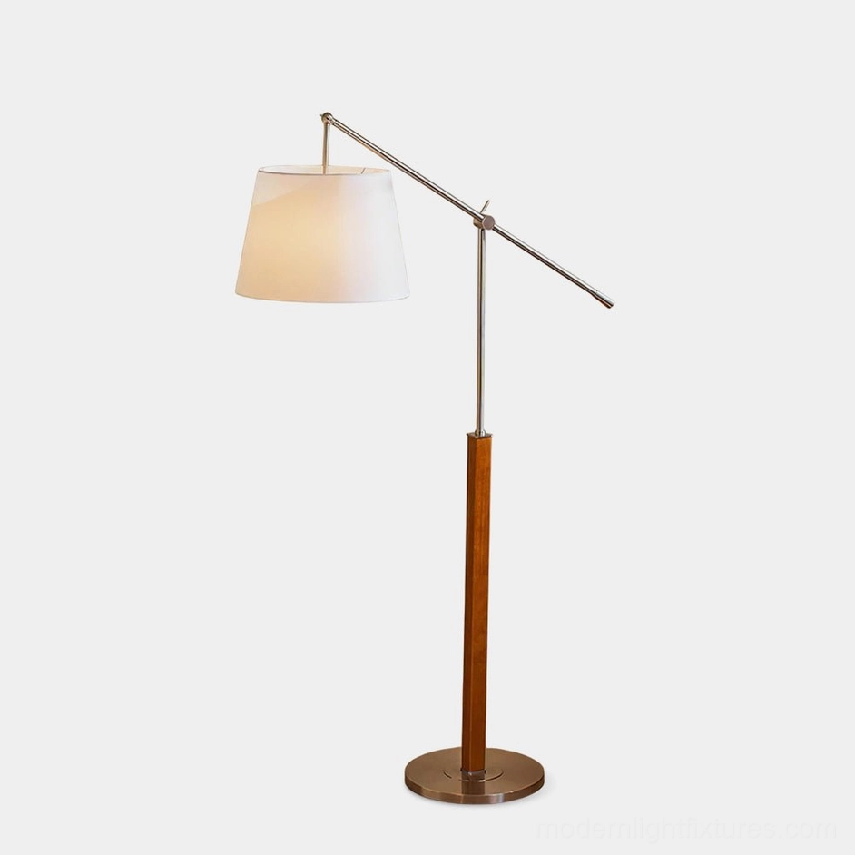 Beamline adjustable floor lamp with walnut wood column and chrome metal base, studio front view on white background