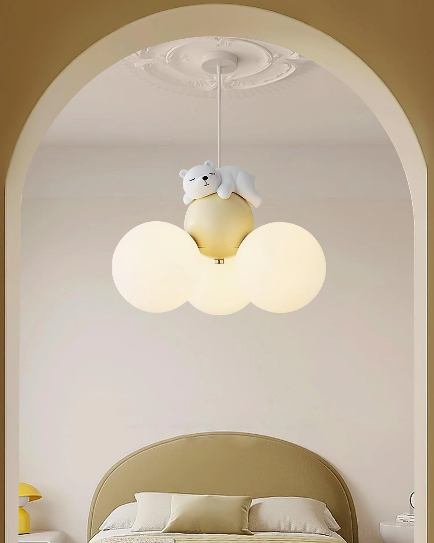 Bear-themed pendant lamp installed above bed in cozy bedroom with arched doorway