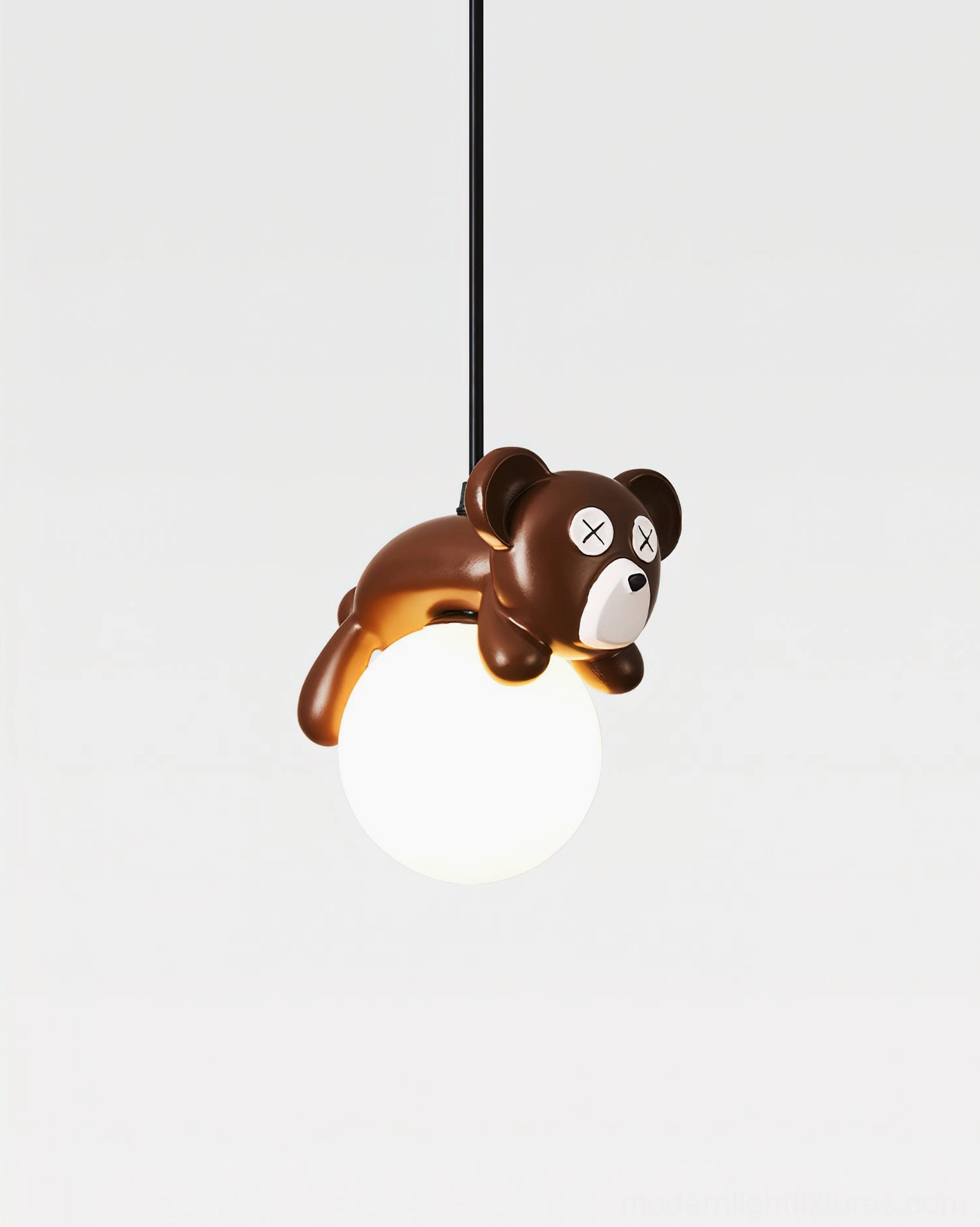 Illuminated frosted glass shade of bear pendant light, left-side overhead angle studio photography
