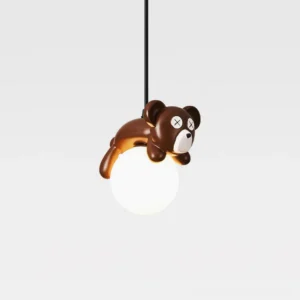 Whimsical bear cartoon pendant lamp with X-shaped eyes, three-quarter angle overhead studio shot