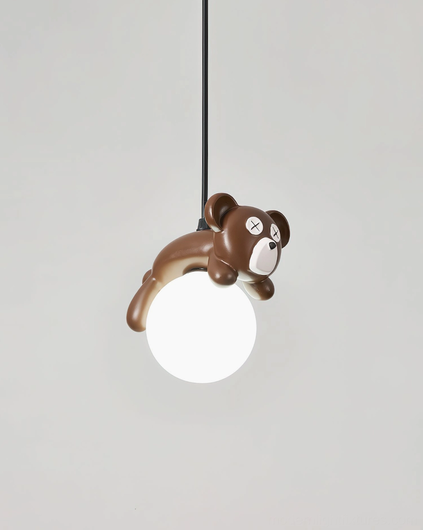 Frosted white glass pendant lamp shade with chocolate resin bear, right-side overhead studio angle