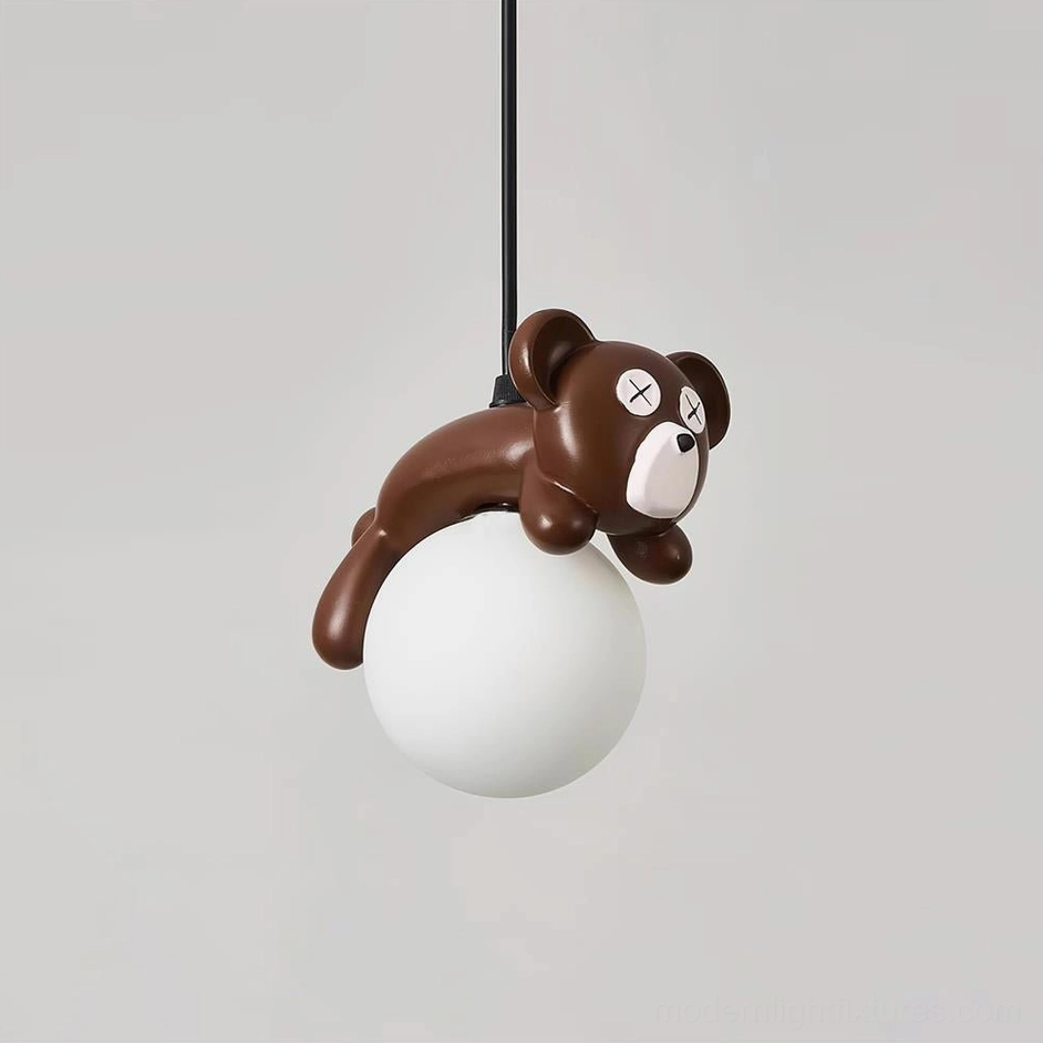 Unlit frosted white glass pendant shade with brown resin bear character, front overhead studio view