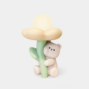 Cute bear resin table lamp with integrated LED, front view on white background, pastel yellow or white matte finish