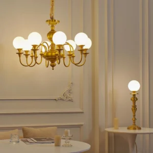 Beatty brass chandelier and matching table lamp displayed in elegant French style dining room interior setting