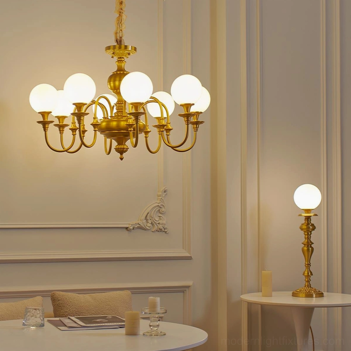 Beatty brass chandelier and matching table lamp displayed in elegant French style dining room interior setting