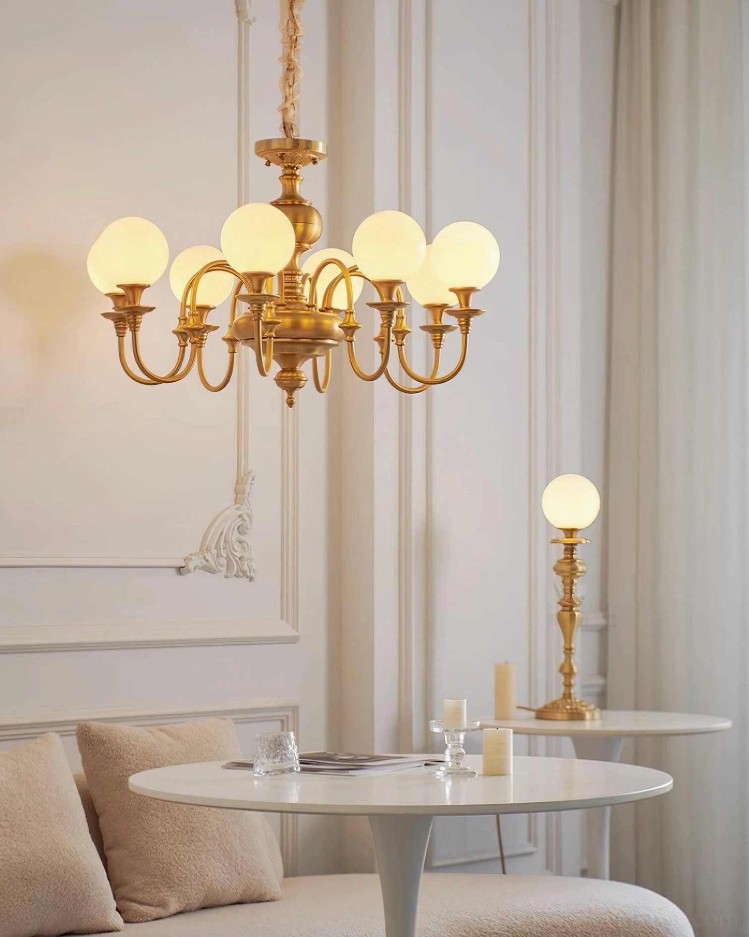 Beatty brass chandelier detailed close-up of frosted glass globe shades and gold brass arms construction