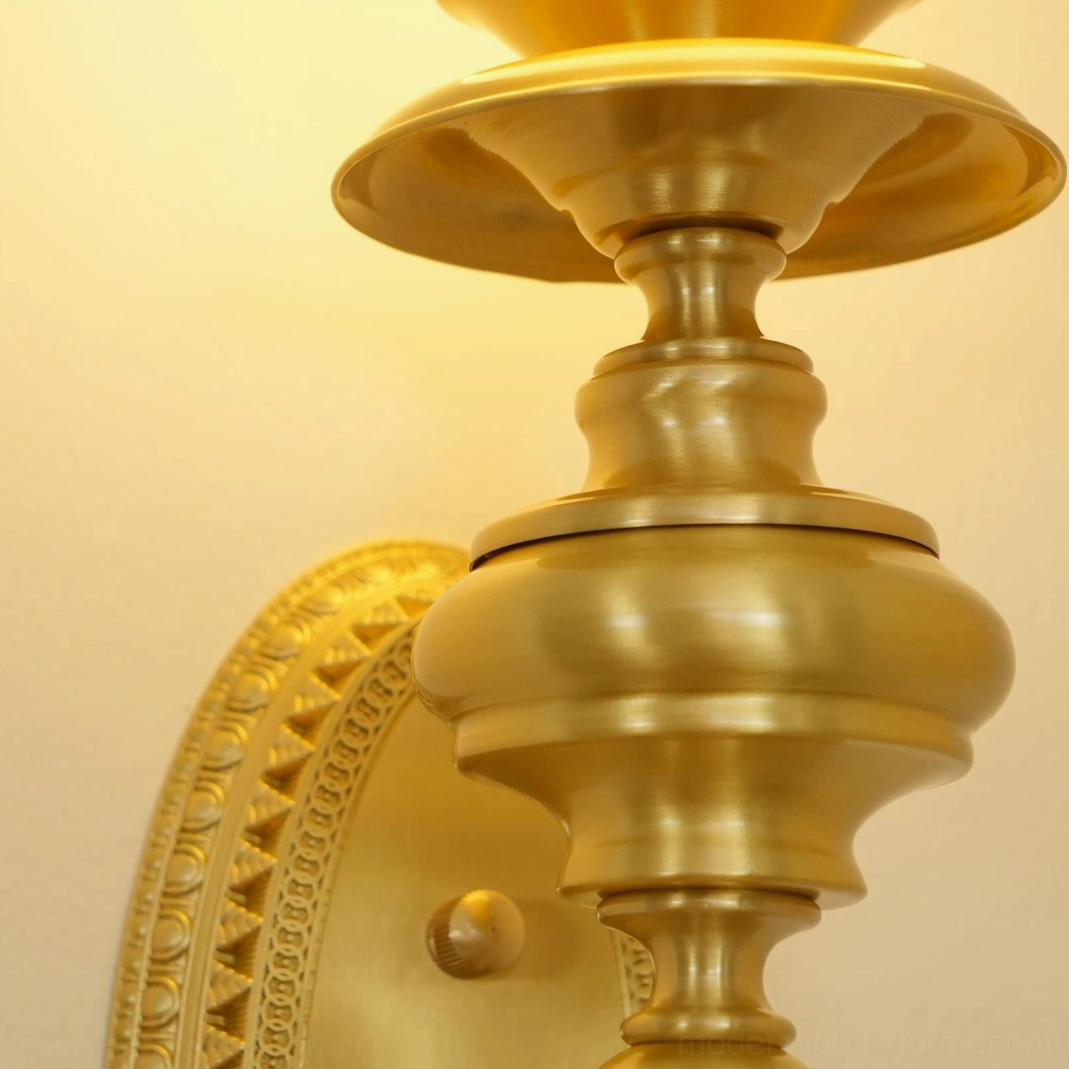 Beatty brass wall sconce creating gallery-like lighting effect in designer home hallway passage