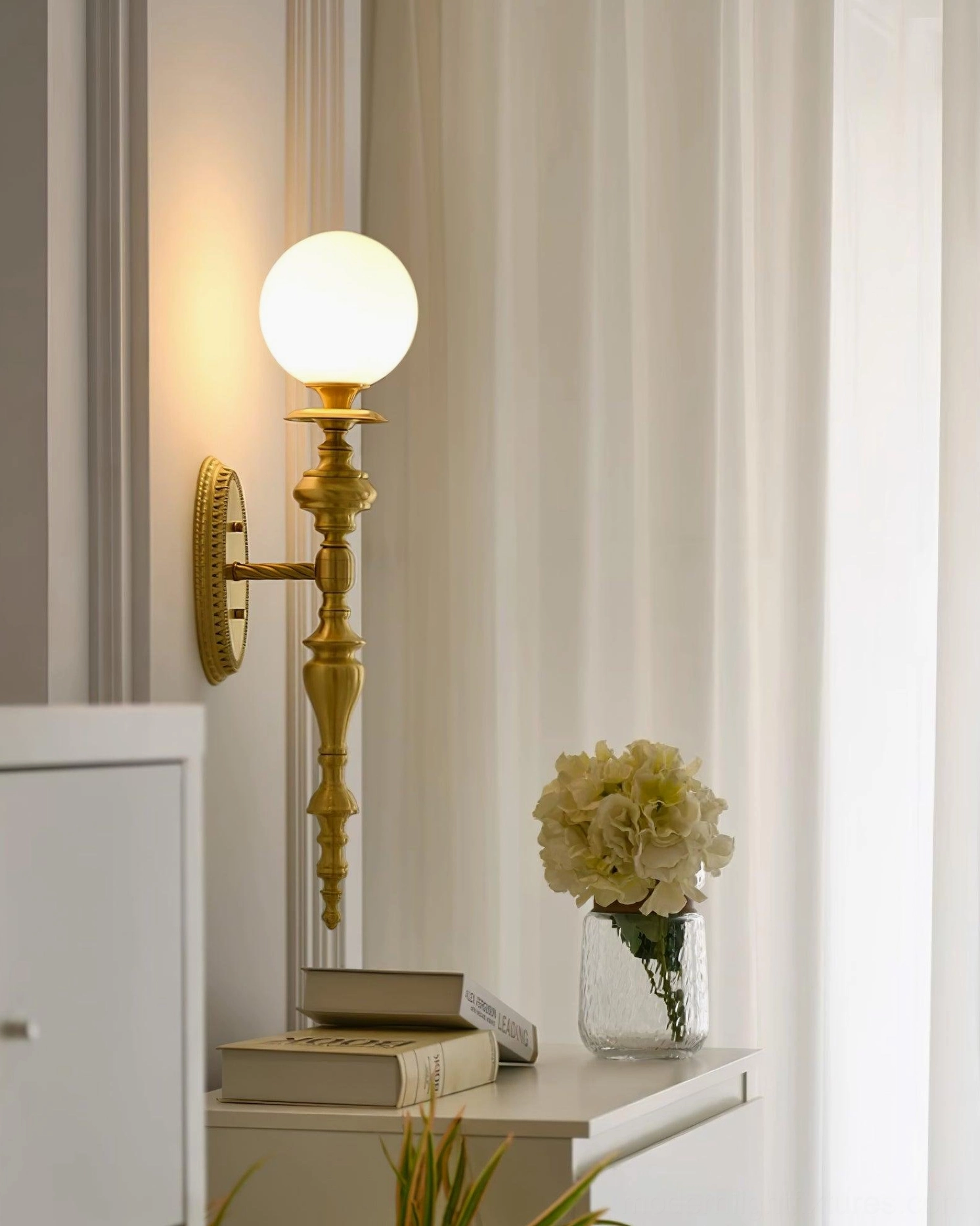 Brass wall sconce in industrial chic setting with exposed brick and contemporary home design