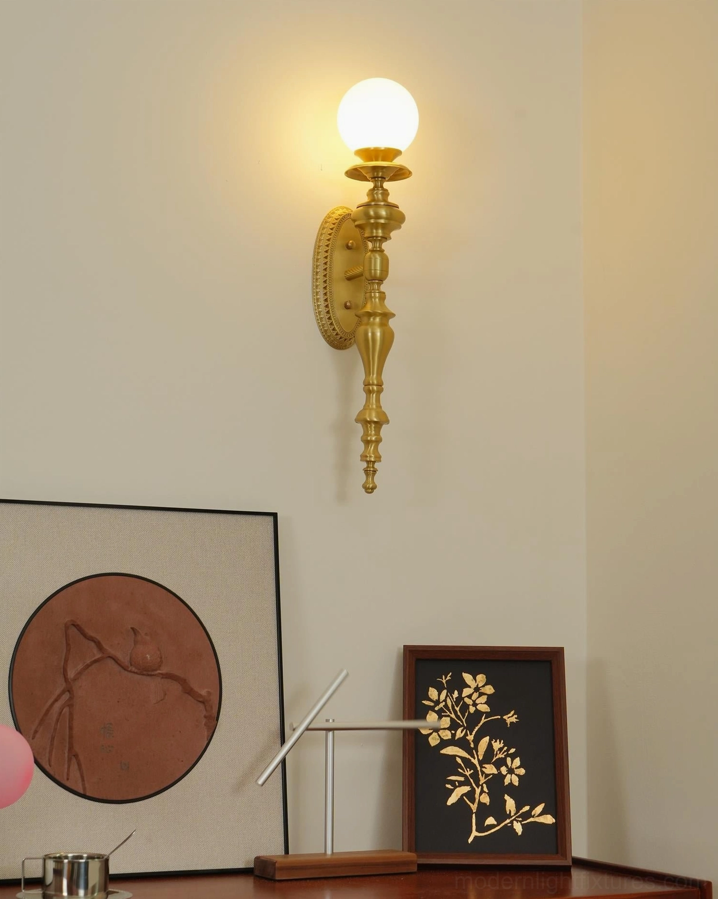 Beatty brass wall sconce side angle showing frosted glass diffuser and polished brass body