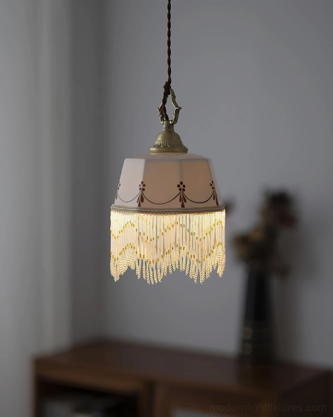 Beaudine pendant lamp featuring premium brass hardware and white ceramic shade with ornamental design