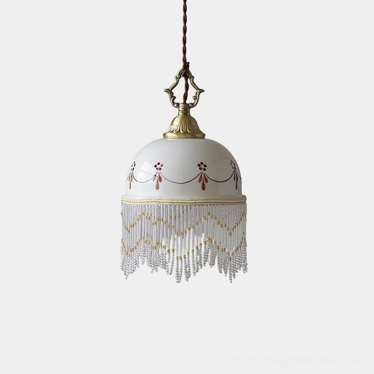 Beaudine hand-painted ceramic pendant light with red ornamental motifs and beaded chevron tassel fringe, overhead studio view