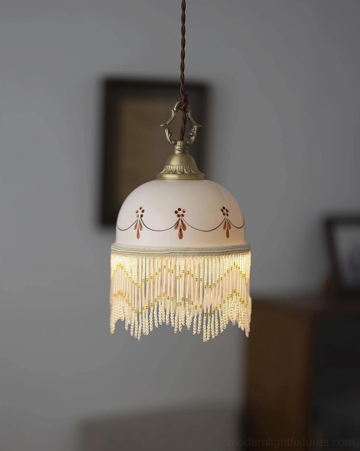 Beaudine pendant lamp with off-white ceramic shade, yellow gradient beaded tassel, red decorative accents