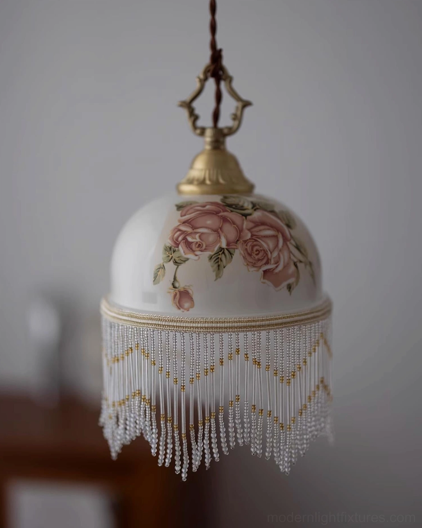 Beaudine pendant light with large pink roses on white ceramic dome, gold hardware, wide chevron beaded trim