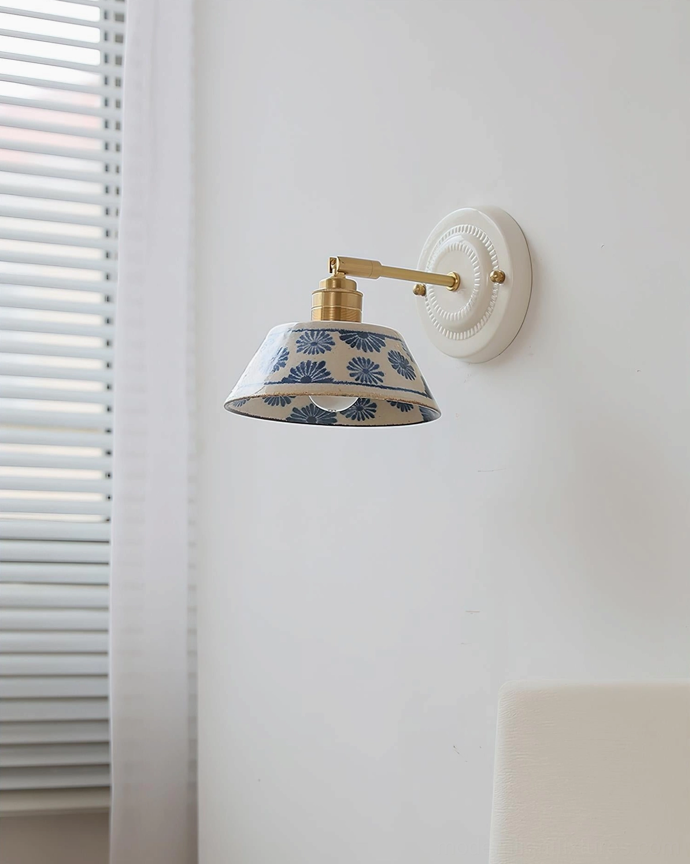Artisan ceramic wall sconce in bedroom accent wall arrangement with soft lighting