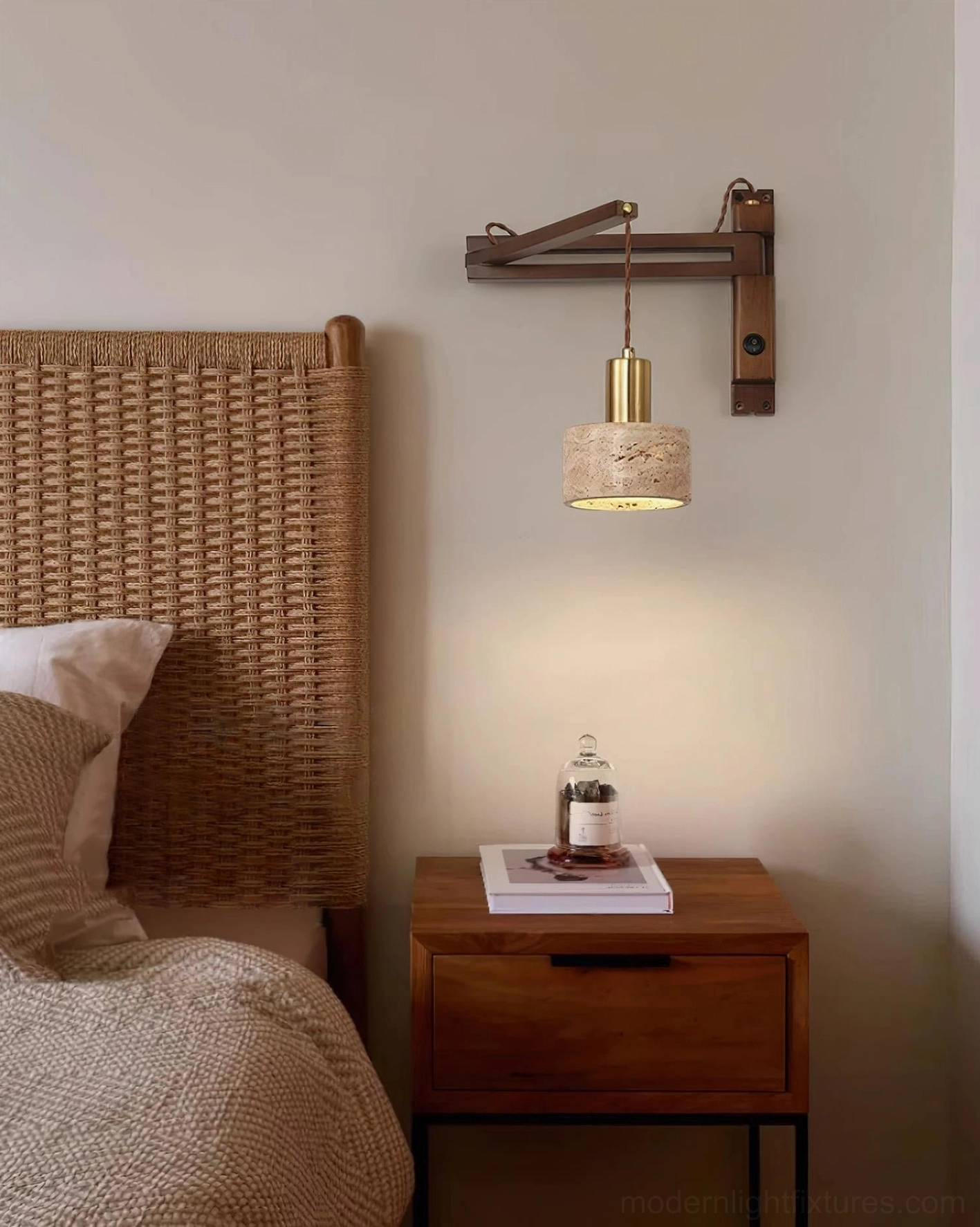 Modern wall sconce installed in contemporary bedroom beside rattan headboard, bedside reading light setup with adjustable arm
