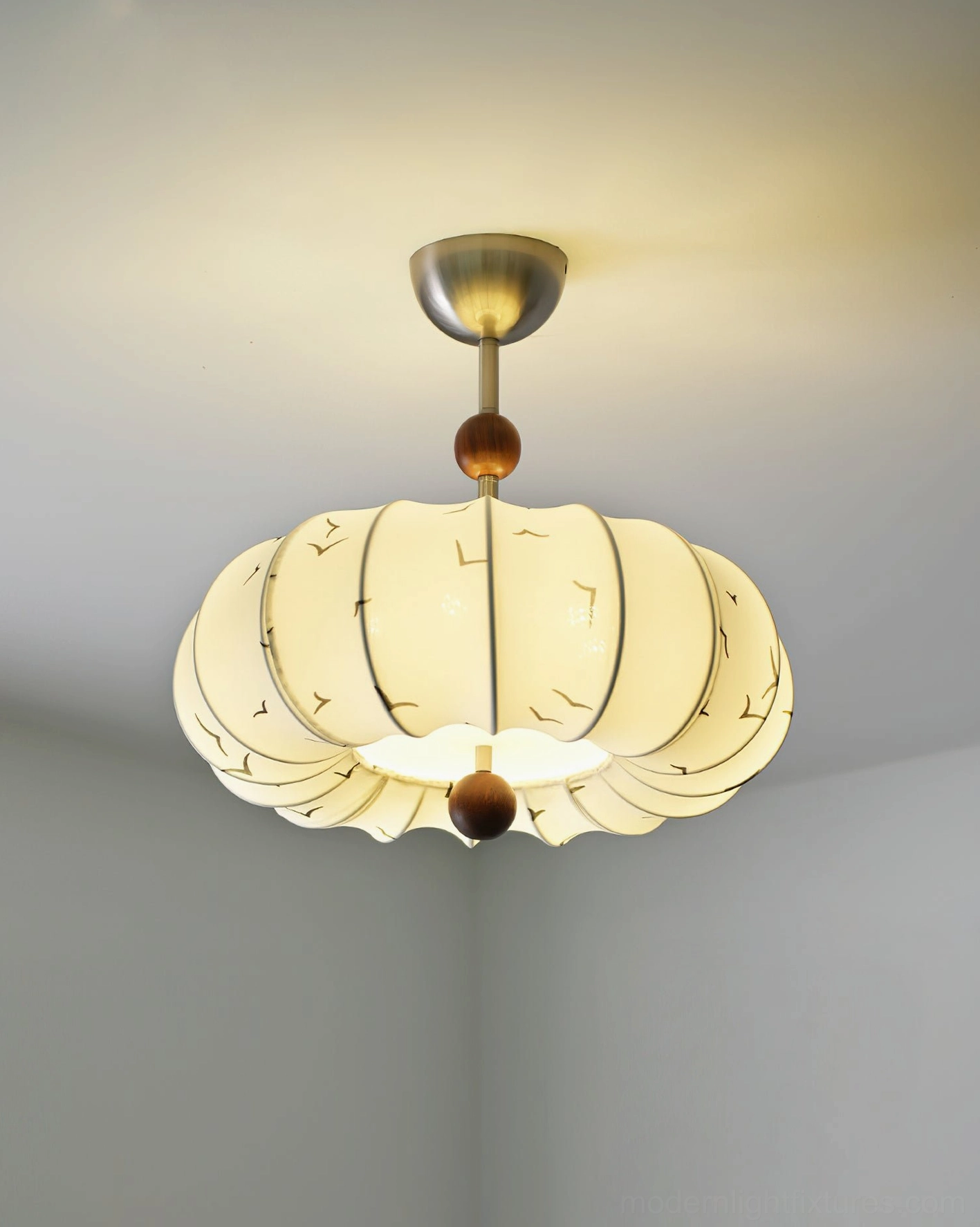 Contemporary bedroom ceiling light fixture - upward angle view illuminated, showing warm light diffusion through fabric shade with subtle seagull details
