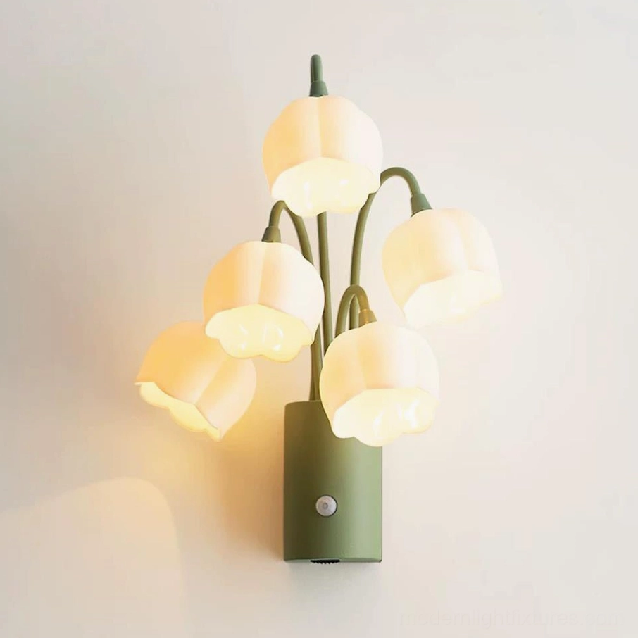 Styled bedroom scene featuring multiple lily-of-the-valley motion-sensor wall sconces creating layered warm ambient lighting