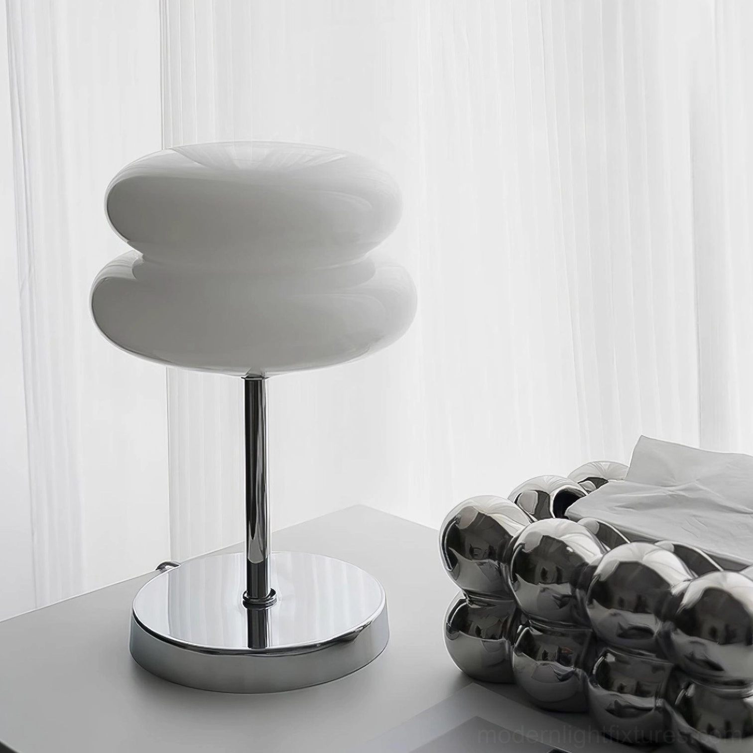 Contemporary glass table lamp on bedroom nightstand creating ambient lighting atmosphere