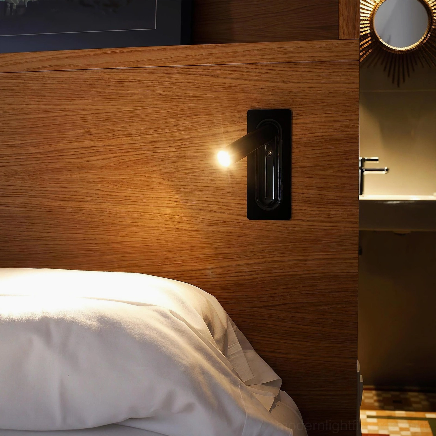 Contemporary bedroom setup with matte black recessed wall reading lamp mounted on wooden headboard for nighttime reading