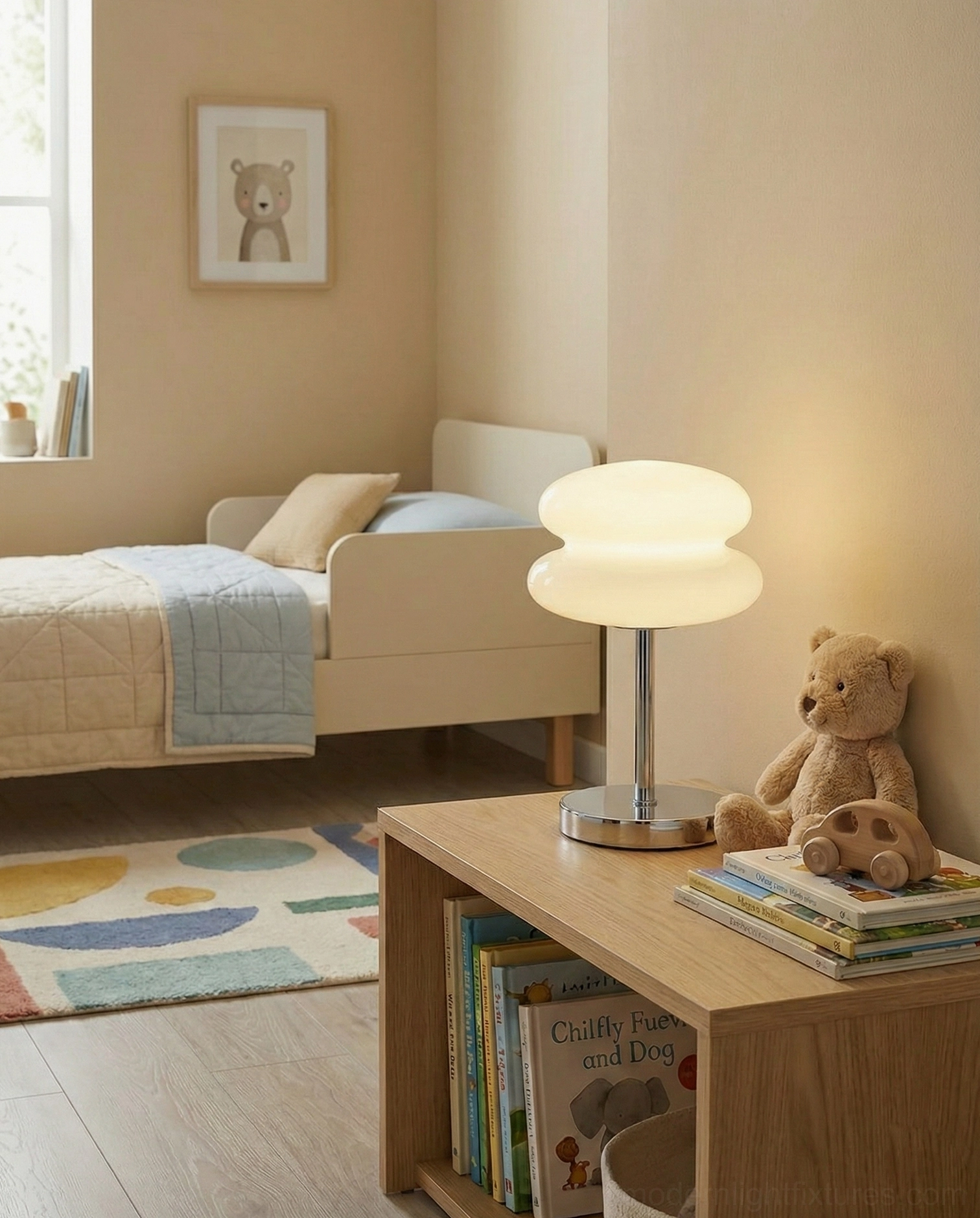 Minimalist chrome and white glass table lamp on bedroom bedside table with books and decor