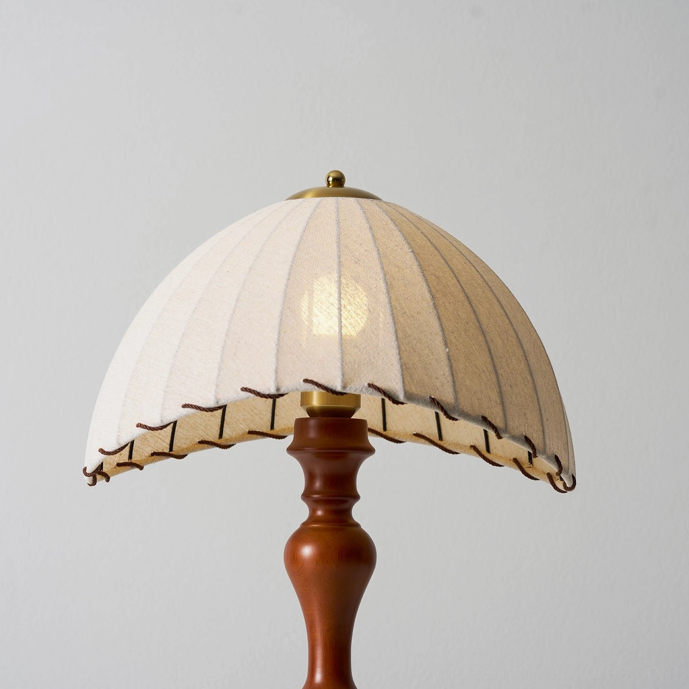 Bedroom table lamp providing soft bedside lighting with rustic fringe details and warm glow