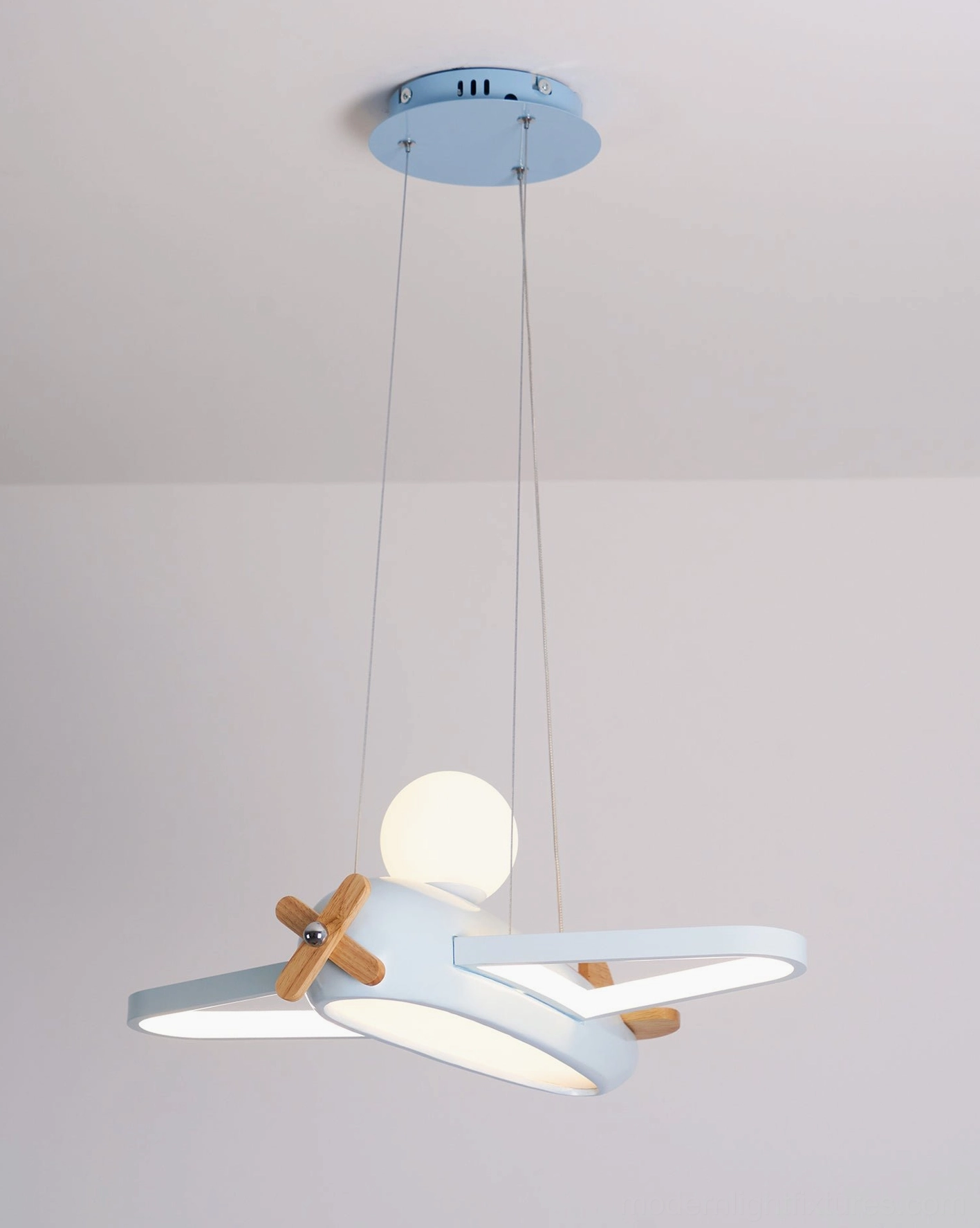 Beige airplane ceiling fixture providing ambient lighting for creative play and learning in kids playroom space