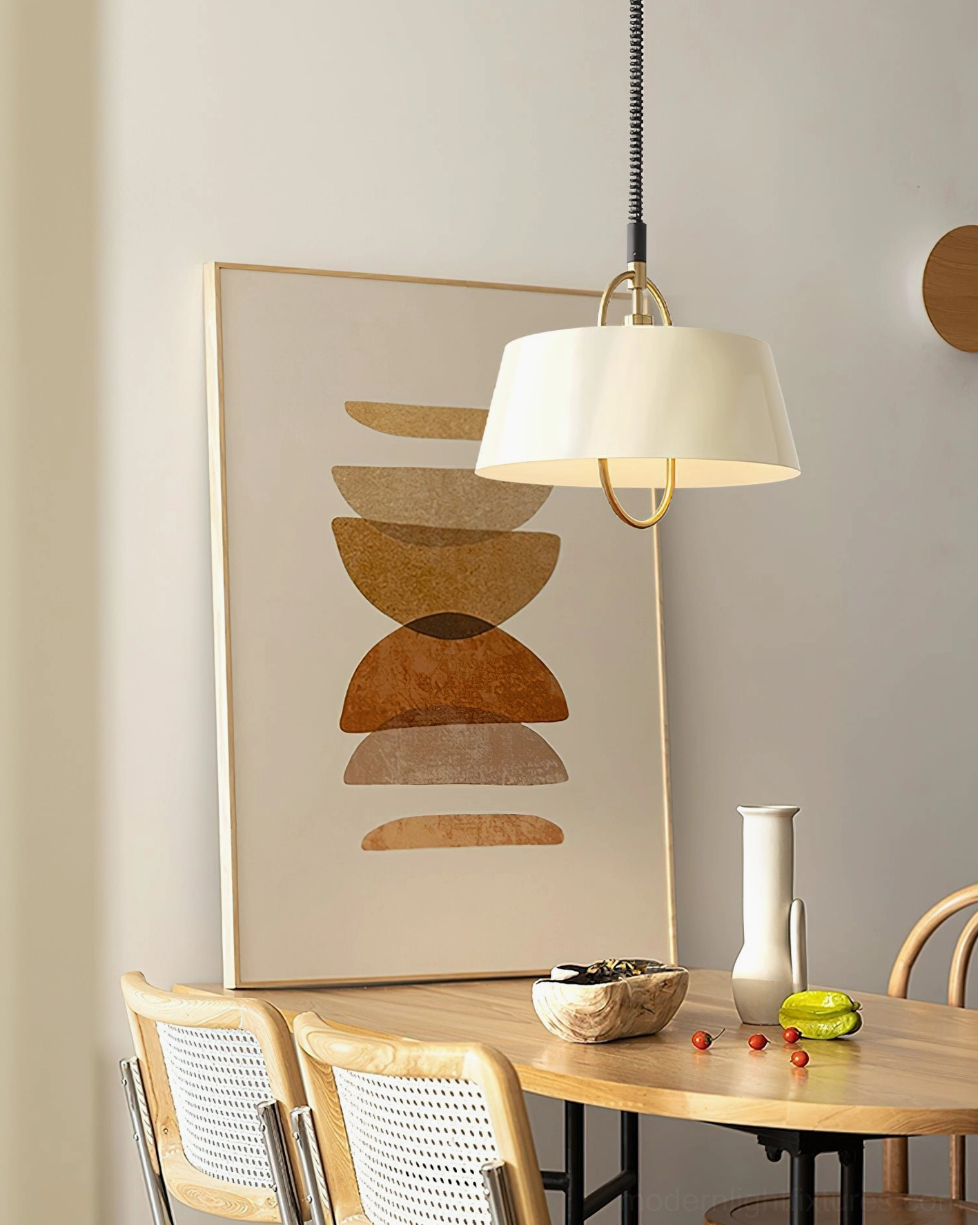 Beige Angelo pendant light installed in modern dining room with neutral interior styling and wall art
