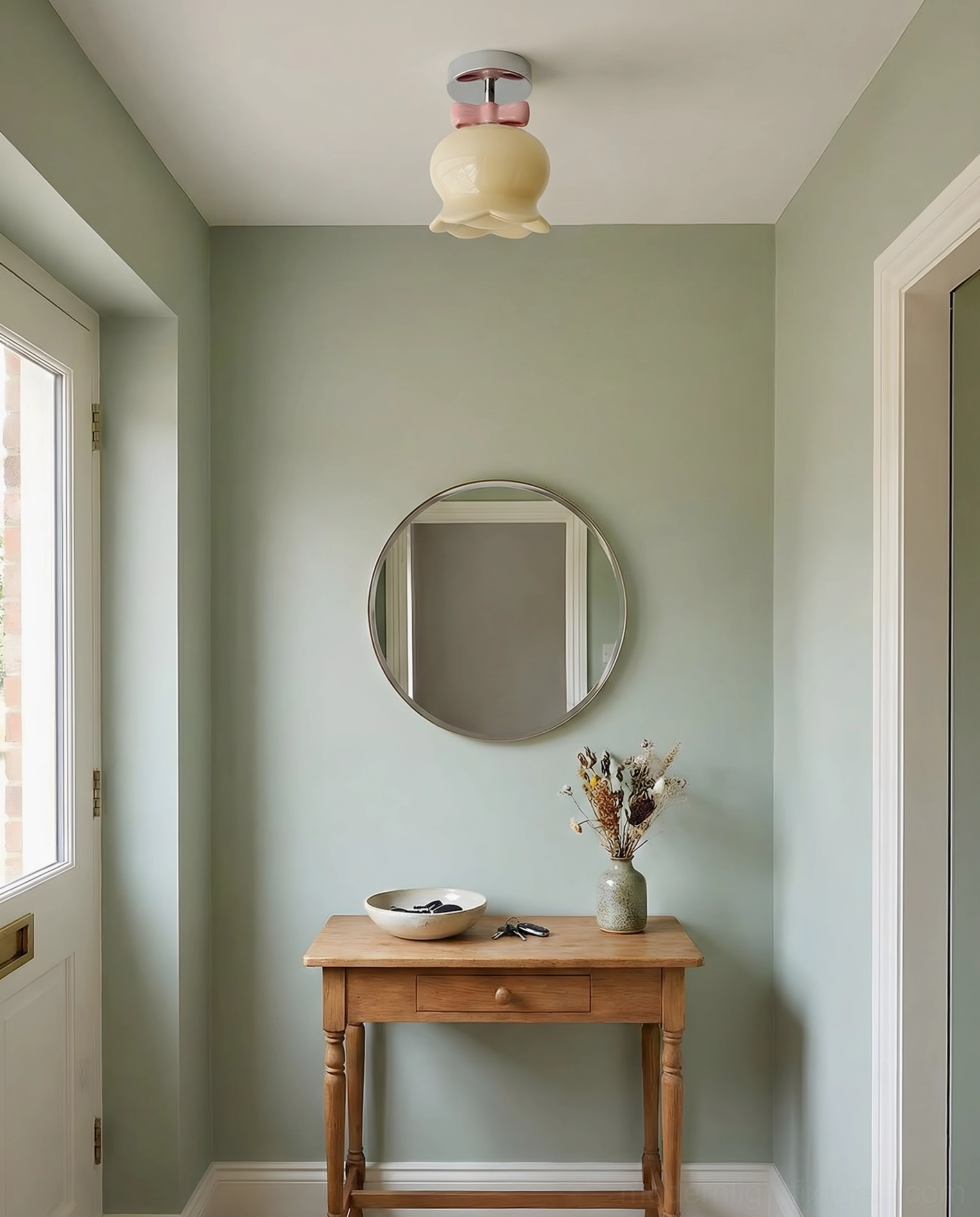 Beige glass bell ceiling light with chrome metal base installed in sage green minimalist entryway, warm neutral contemporary aesthetic