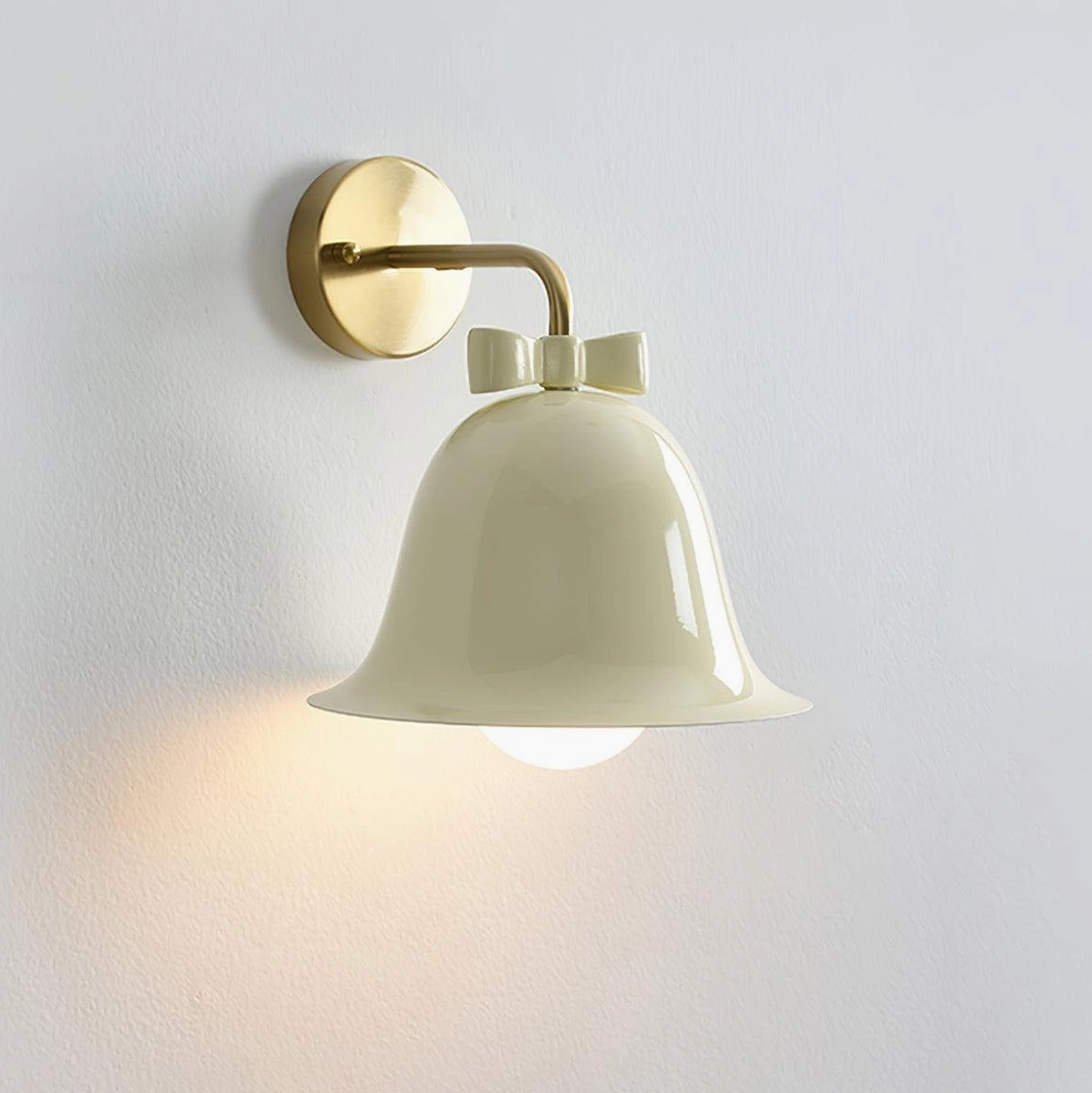 Cute minimalist Nordic ceramic bell sconce with beige bow knot detail and brass mounting hardware
