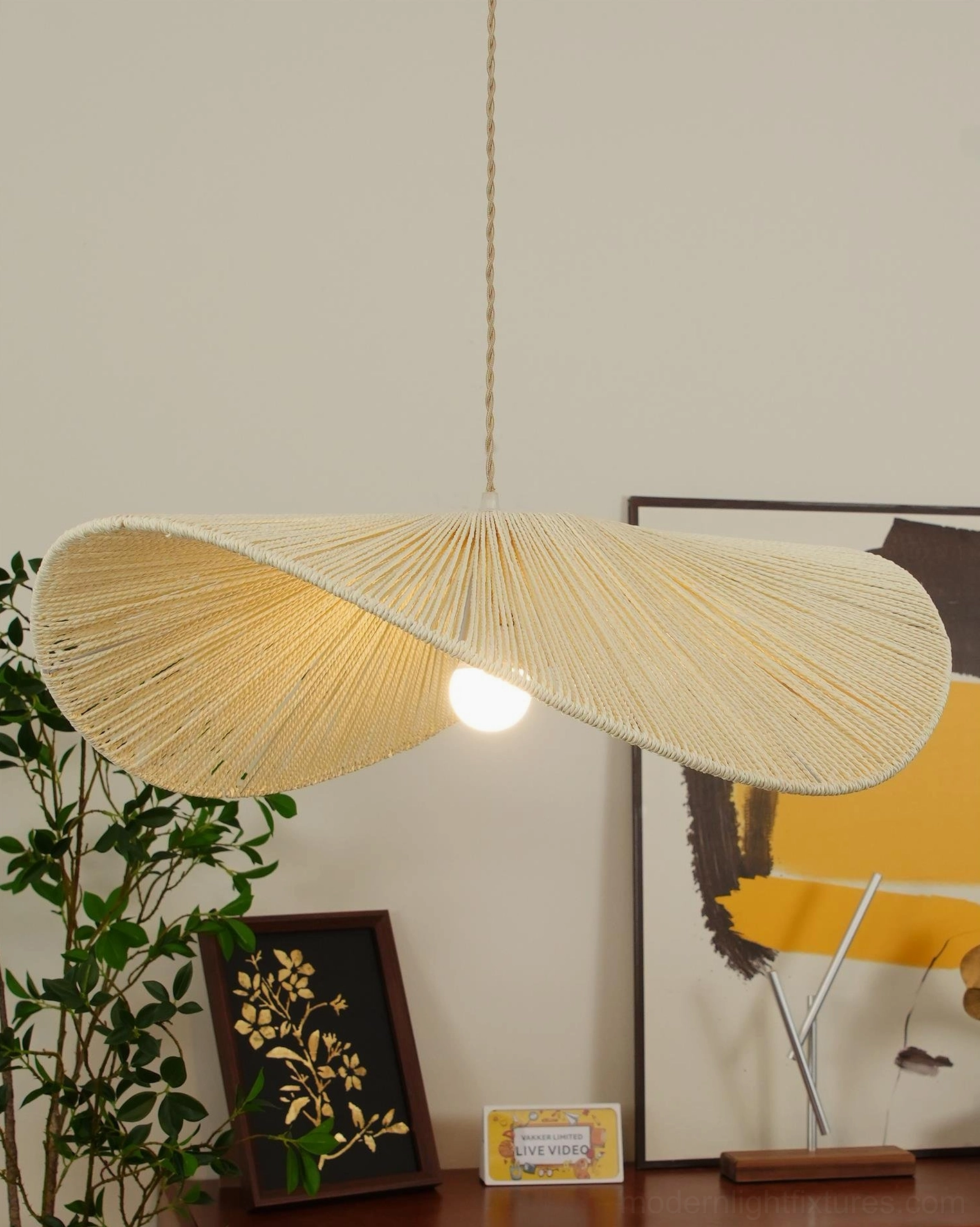 Soft beige woven rope straw hat pendant fixture with exposed bulb in cozy residential living room