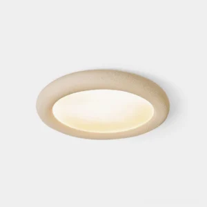 Beige minimalist round flush mount ceiling light with matte textured finish, studio product shot against white background showing clean geometric design