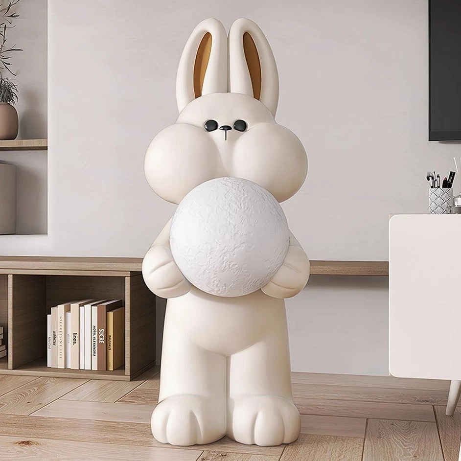 Beige rabbit floor lamp with moon-shaped shade in modern living room with bookshelf interior design setting