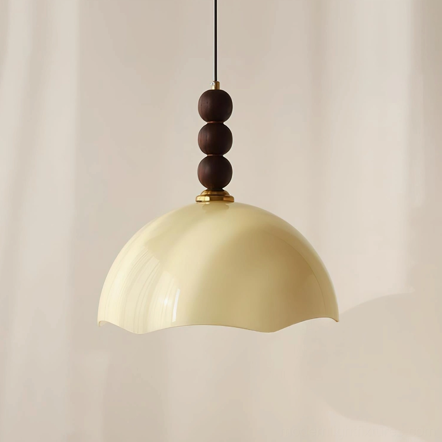 Beige rippled glass pendant light with walnut wood sphere detail in hygge-inspired cozy reading nook setting