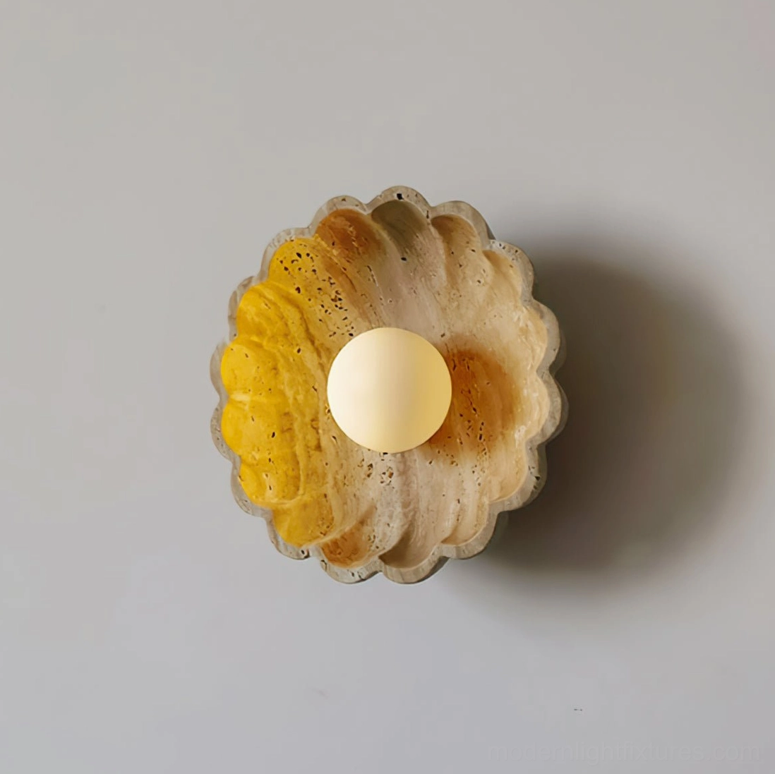Beige scallop shell wall sconce paired styling with organic home decor and natural materials