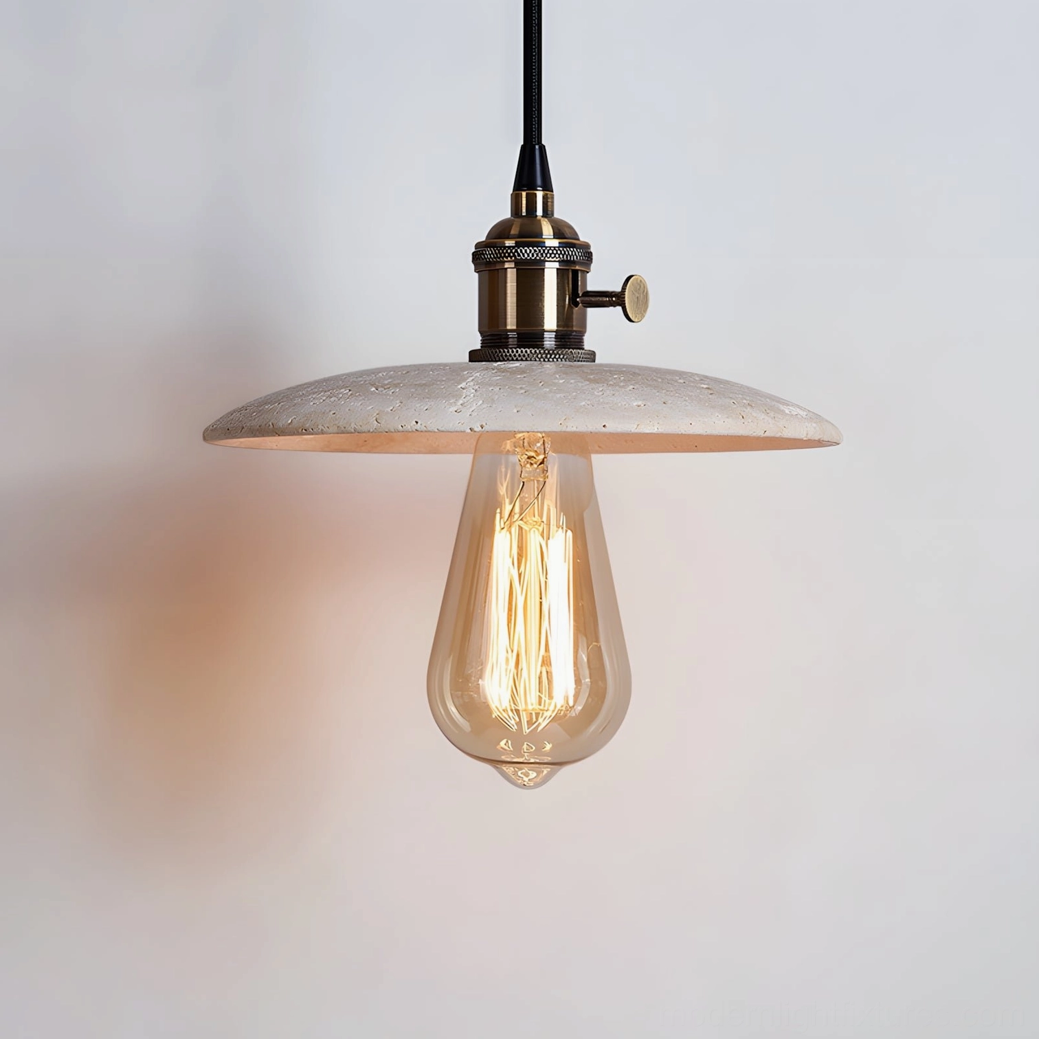 Beige travertine pendant light with matching metal hardware in warm neutral tone