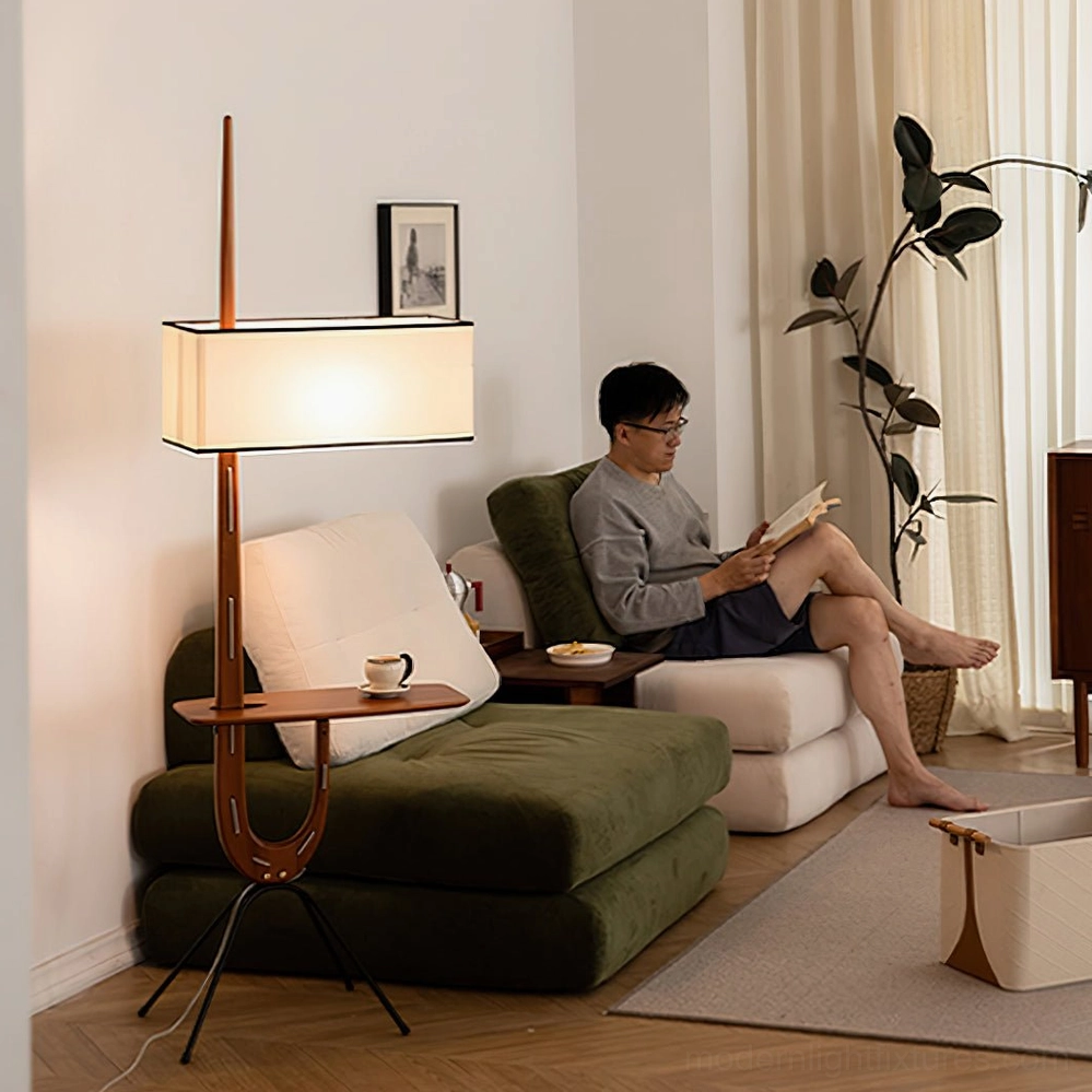 Beige wood floor lamp with tripod base and wooden shelf in scandinavian styled living room