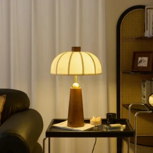 Belane table lamp with ribbed cream fabric shade and brown wooden base displayed on side table in contemporary living room setting, mid-century modern interior design