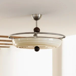 Belden ceiling lamp three-quarter overhead angle showing wooden decorative accents and cream glass shade against exposed wooden beams