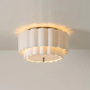 Overhead low-angle view of Beline ceiling lamp installed on ceiling showing warm backglow effect through pleated fabric shade