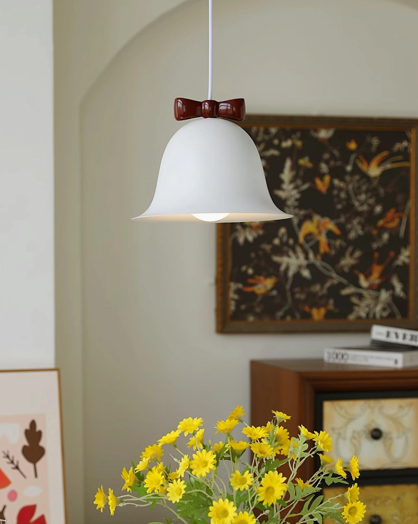 Bell pendant light with decorative bow accent in bedroom alcove ambient lighting setup