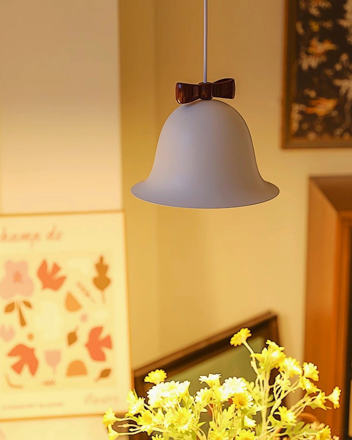 Bell pendant light with decorative bow detail in eclectic home interior design setting