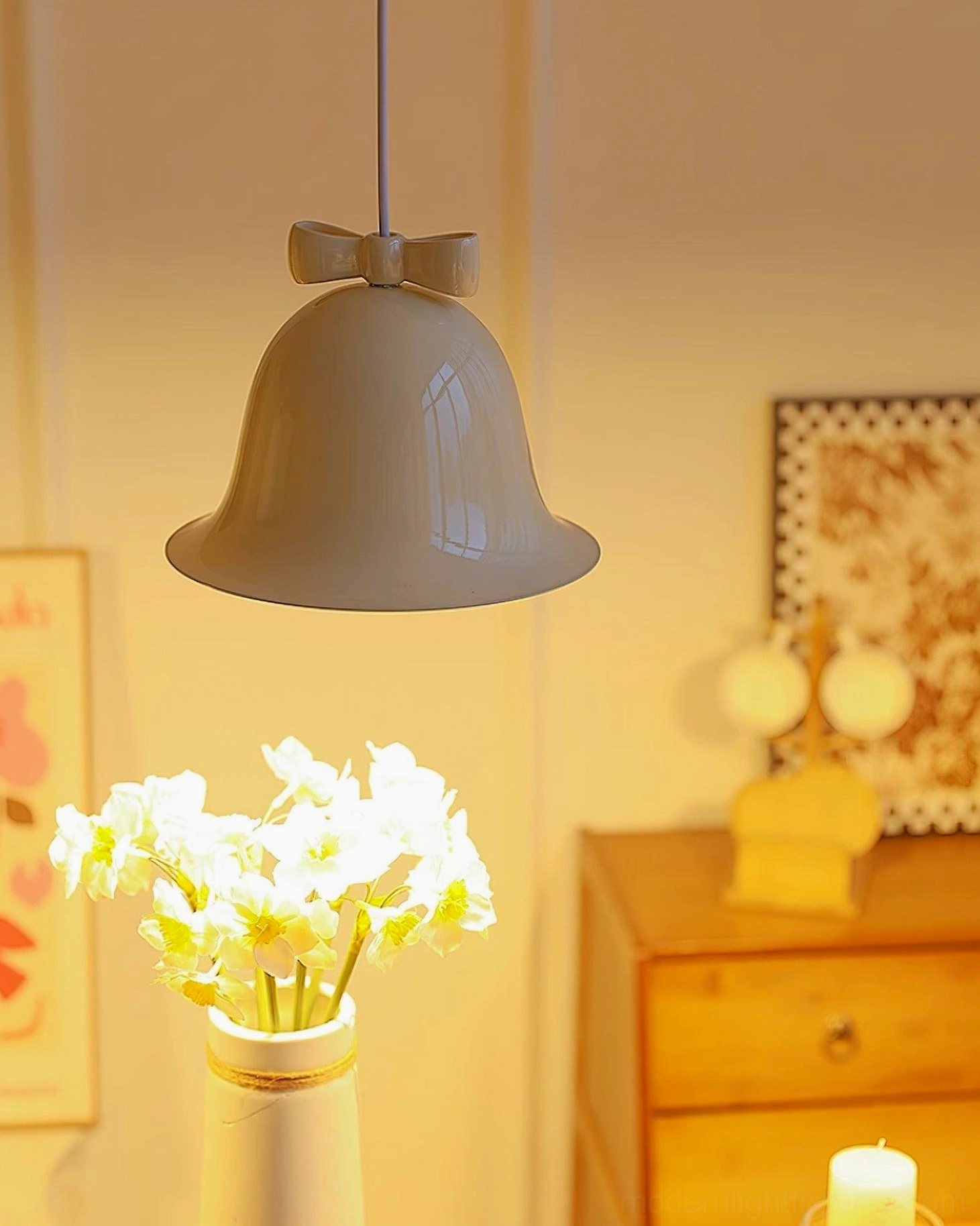 Ceramic bell pendant light with bow ornament hanging in contemporary modern interior space
