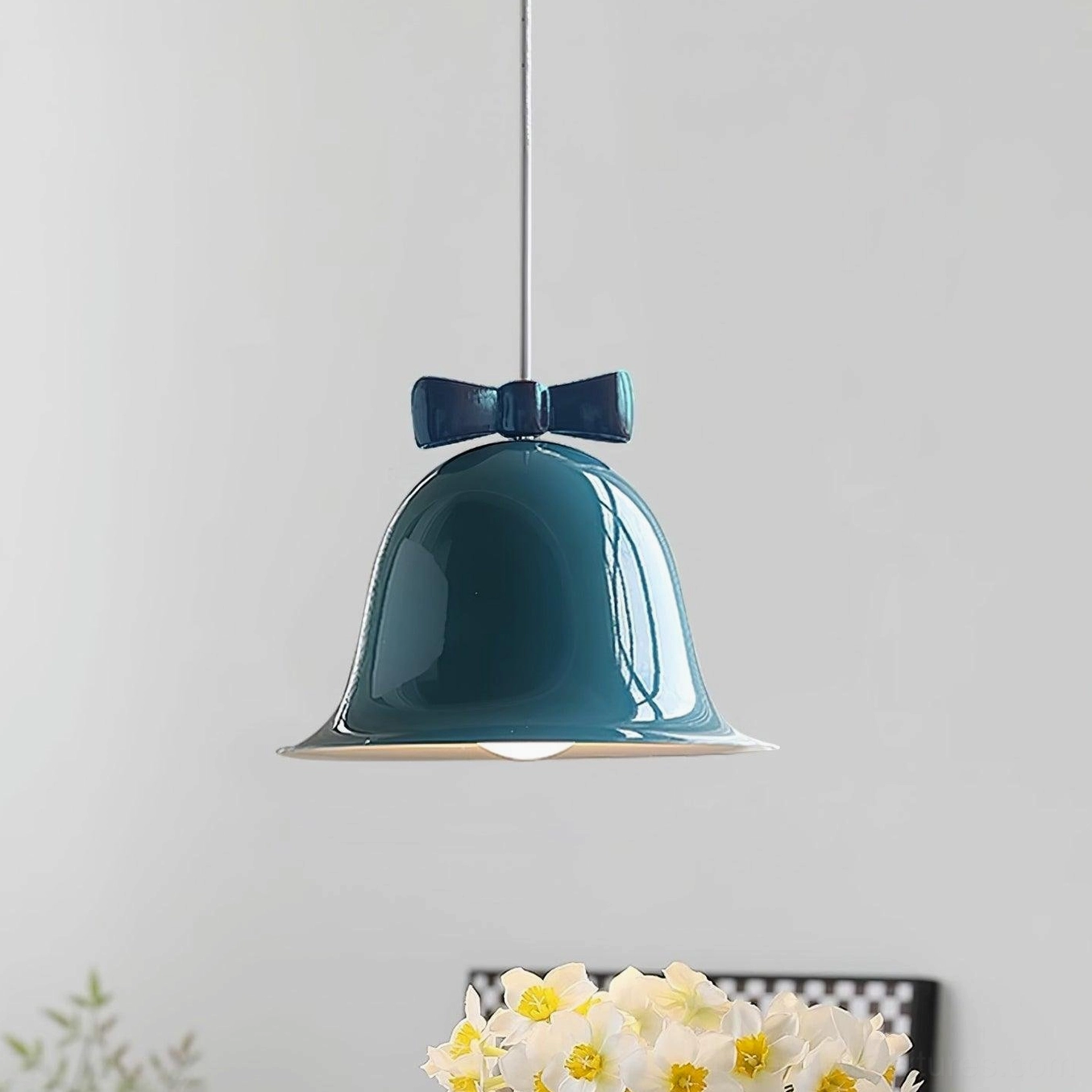 Bell pendant light with bow detail in minimalist modern home interior styling photography