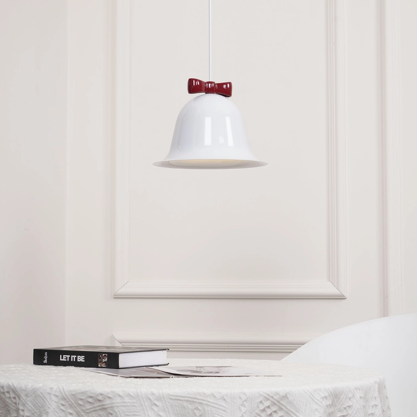 Bell pendant lamp with bow ornament product photography gallery studio scene