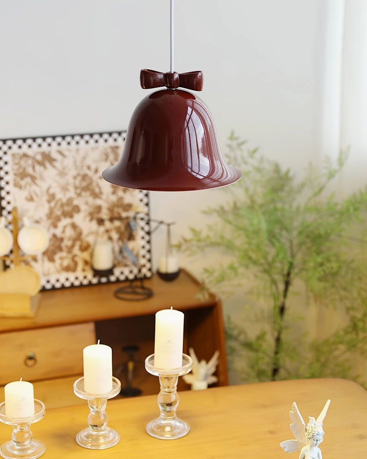Ceramic bell pendant light with decorative bow in minimalist Scandinavian home setting