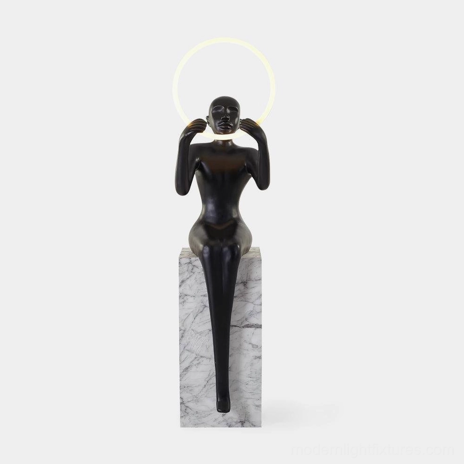 Bella sculptural halo floor lamp with matte black finish and LED ring light, front view on white studio background